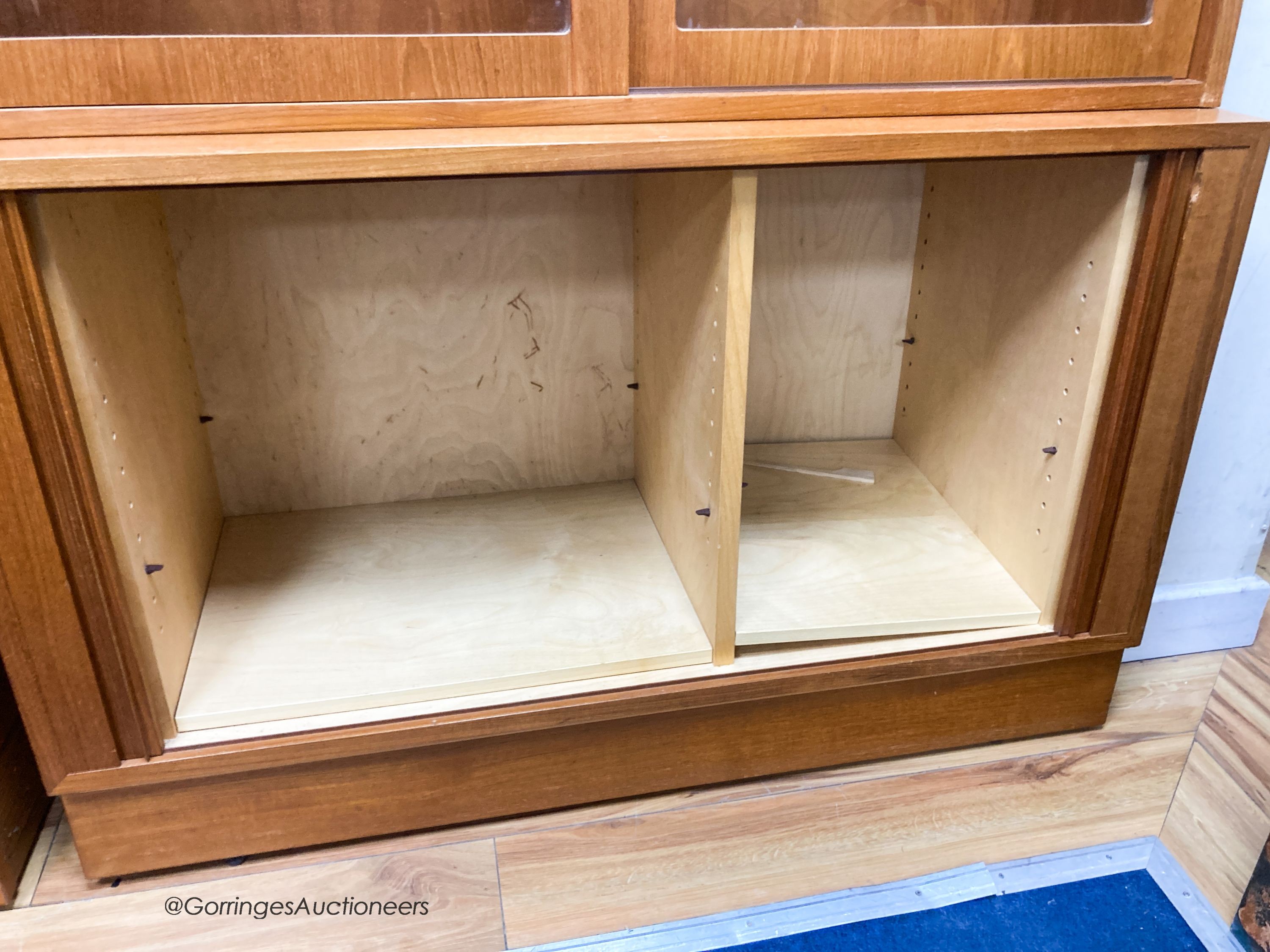 A pair of Harrods teak display cabinets, width 108cm, depth 43cm, height 196cm